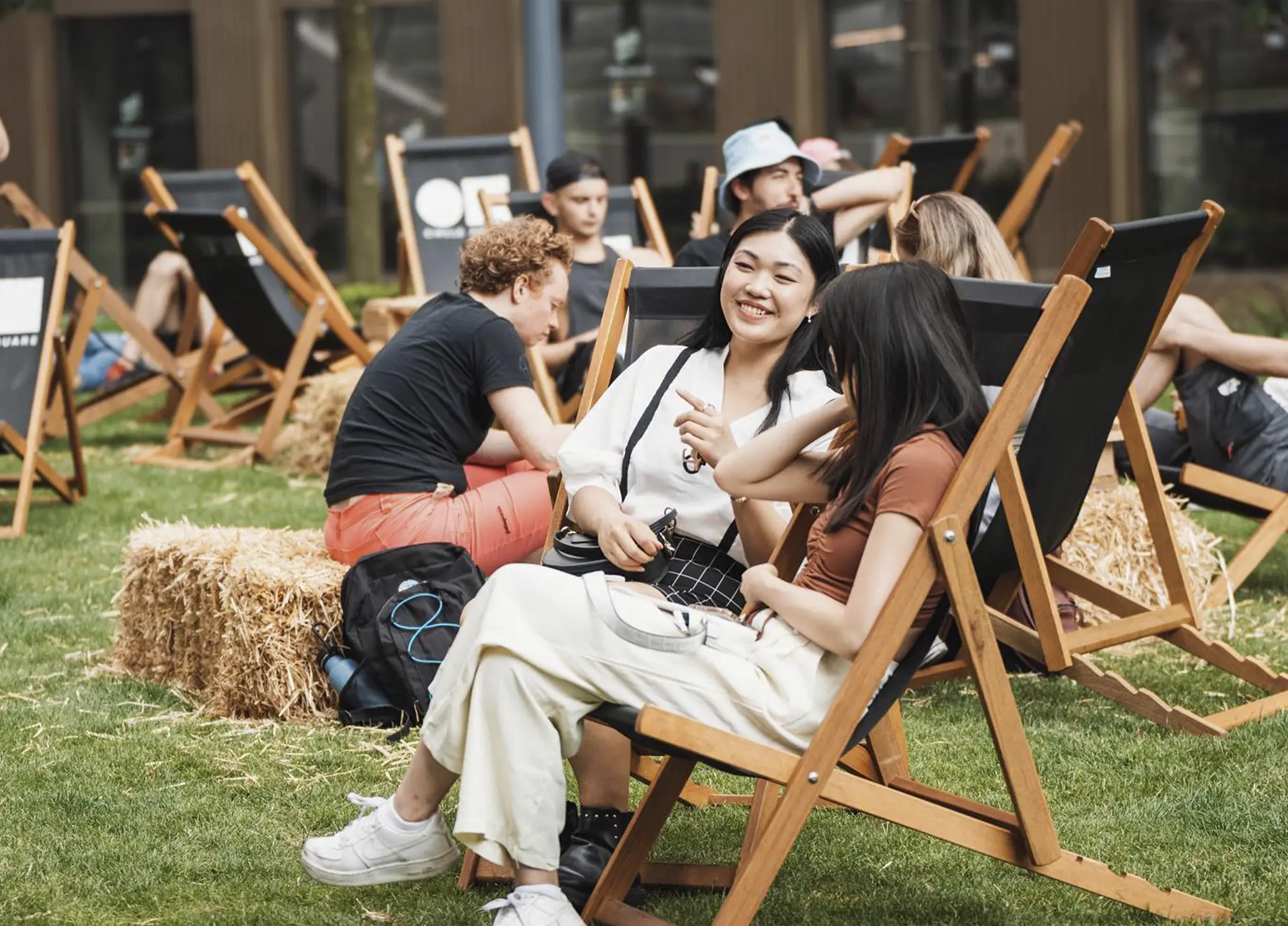 Residents relaxing in deckchairs on the lawn at Circle Square, Manchester, on a summer afternoon